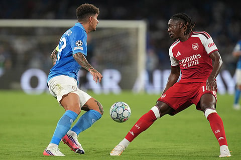 Arsenal's Eberechi Eze, right, and Napoli's Giovanni Di Lorenzo challenge for the ball during their Champions League soccer match between Napoli and Arsenal, in Naples, southern Italy.