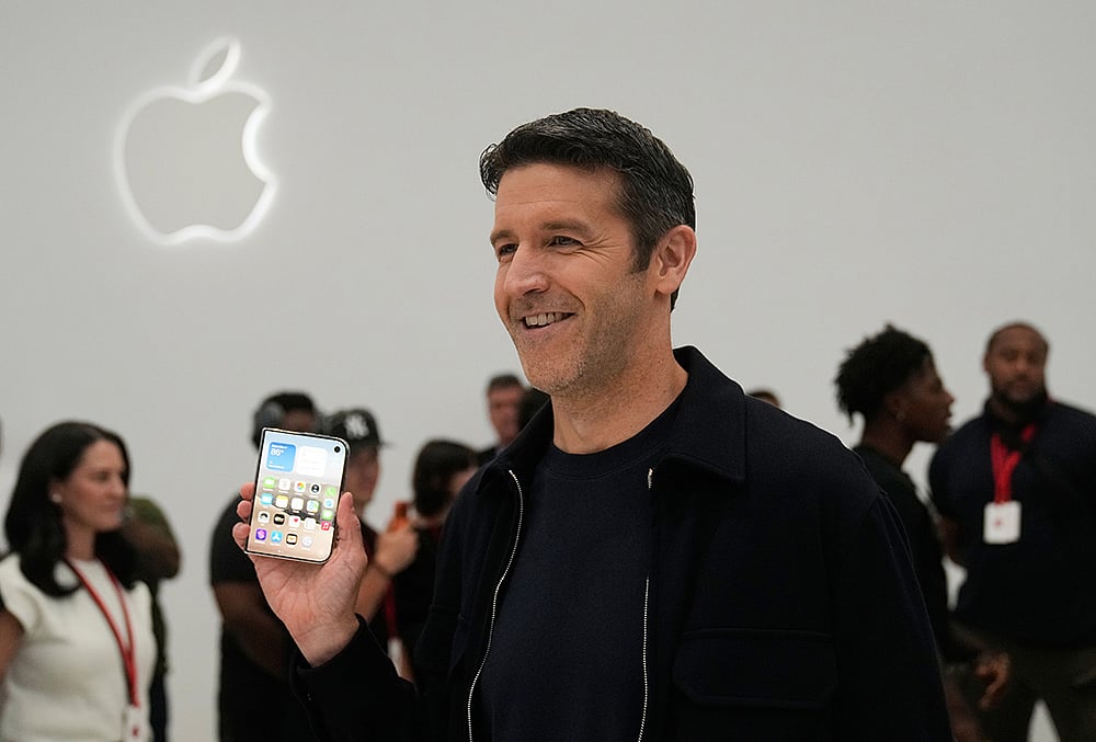 John Ternus holding iPhone Duo photo
