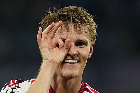 Arsenal's Martin Odegaard celebrates after scoring the opening goal during their Champions League soccer match between Napoli and Arsenal, in Naples, southern Italy,