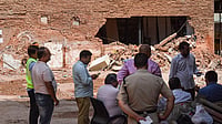 | Photo: PTI/Rushikesh More : Police officials and people gather at the site during a rescue operation following the collapse of a multi-storey building housing a PG accommodation at Satya Niketan, in New Delhi. Atleast seven people were killed. 