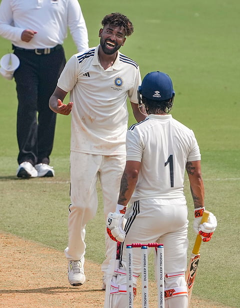 South Zone's Mohammed Siraj, back, shares a light moment with East Zone's captain Ishan Kishan on day 1 of the Duleep Trophy 2026-27 final cricket match between South Zone and East Zone, in Chennai, Sunday, Sept. 6, 2026. 
