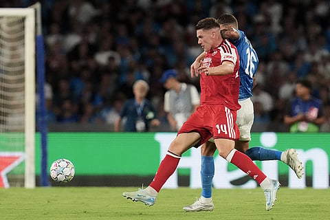 Arsenal's Viktor Gyoekeres, front, and Napoli's Rafa Marin challenge for the ball during their Champions League soccer match between Napoli and Arsenal, in Naples, southern Italy.