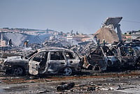In Photos | Explosion at Weapons Depot Sparks Massive Fire in Syria’s Idlib Province | Photo: AP/Omar Albam : Firefighters work among rubble and burned-out vehicles at the site of an explosion at what Syria's Defense Ministry said was a warehouse used for the temporary storage of weapons near Sarmada, in Idlib province, Syria, Wednesday, Sept. 9, 2026.