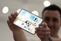 | Photo: AP/Jeff Chiu : An attendee holds up an iPhone Duo during an announcement of new products on Wednesday, Sept. 9, 2026, on the Apple campus in Cupertino, California. 