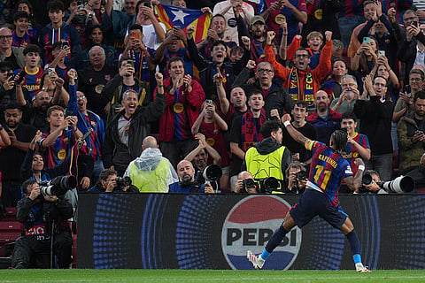 Barcelona's Raphinha celebrates after scoring his side's third goal during the Champions League opening phase soccer between Barcelona and Feyenoord in Barcelona, Spain.