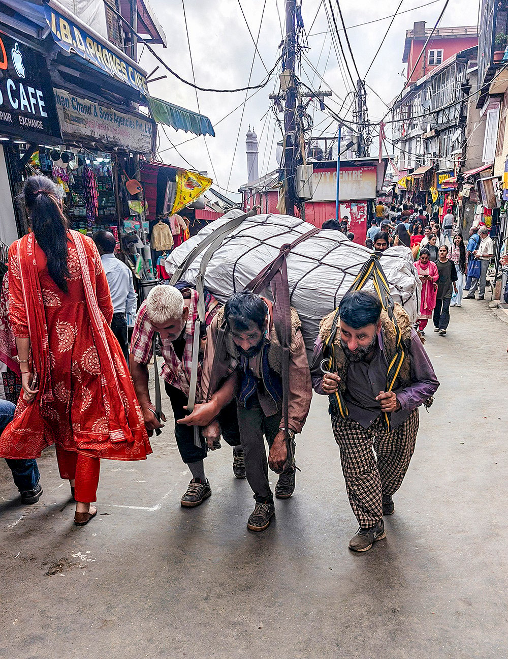 Kashmiri porters carry heavy loads on their backs