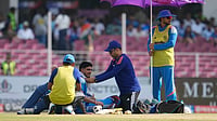 Team India Hit By Support Staff Exit As Kamlesh Jain Resigns From Physio Role | Photo: AP/Manish Swarup : A physio puts cold towel around the neck of India's captain Shubman Gill as a teammate stands with an umbrella to beat the heat during the second ODI cricket match between India and Afghanistan in Lucknow.