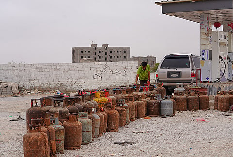 A worker prepares gas cylinders for refilling at a gas station in Mahra, Yemen, Wednesday, Sept. 9, 2026. 