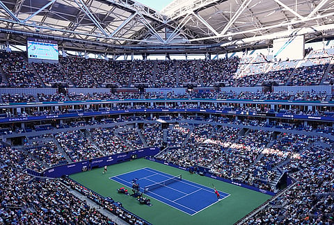 Karen Khachanov, of Russia, right, serves to Alexander Zverev, of Germany, left, during the men's singles semifinals of the U.S. Open tennis championships, Friday, Sept. 11, 2026, in New York. 