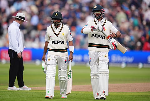 Pakistan's Babar Azam, left, and Shan Masood walk off at lunch on day three of the third cricket Test in Birmingham, England, Friday Sept. 11, 2026.