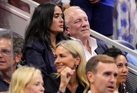 Actress Salma Hayek, left, and her husband François-Henri Pinault attend a match between Ben Shelton, of the United States, and Frances Tiafoe, of the United States, during the men's singles semifinals of the U.S. Open tennis championships Friday, Sept. 11, 2026, in New York.