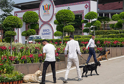 Security officials with sniffer dogs arrive to conduct a check ahead of the 18th BRICS Summit, outside Bharat Mandapam, in New Delhi, Saturday, Sept. 12, 2026. 
