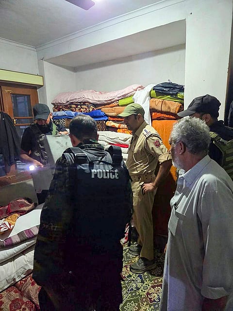 Security personnel at the residence of Kifayat Ahmad Koka, son of late Mubarak Ahmad Koka, a resident of Bugam, as a team of the National Investigation Agency (NIA) conducts a search operation, in Kulgam, Jammu and Kashmir.