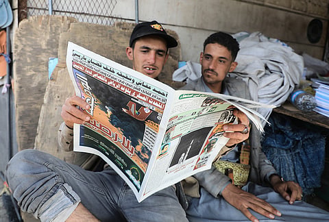 People read a newspaper to follow the war news at a shop in Sanaa, Yemen, Tuesday, Sept. 8, 2026. Arabic on the from page reads, "military spokesman promised Riyadh to revenge for civilians blood". 