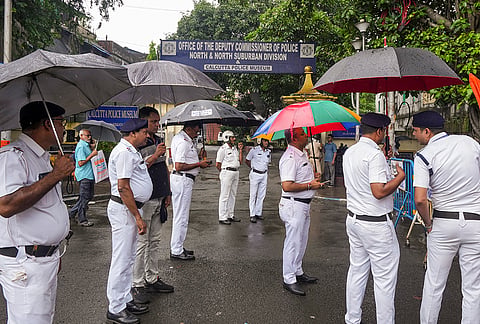 Police official present as Congress activists stage a protest outside the Deputy Commissioner of Police (North) office following the arrest of party South Kolkata district general secretary Atanu Das for allegedly burning a photograph of Bageshwar Dham chief priest Dhirendra Krishna Shastri during a protest against the self-styled godman's remarks on meat during Durga Puja and over the plight of incarcerated Bangladeshi Hindu monk Chinmoy Krishna Das Prabhu, in Kolkata, West Bengal.