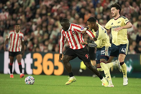 Sunderland's Brian Brobbey, left, and Arsenal's Ezri Konsa challenge for the ball during the English Premier League soccer match between Sunderland and Arsenal in Sunderland, England.