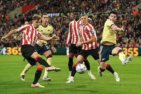 Arsenal's Declan Rice, right, tries to block a shot from Sunderland's Thomas Meunier, left, during the English Premier League soccer match between Sunderland and Arsenal in Sunderland, England.