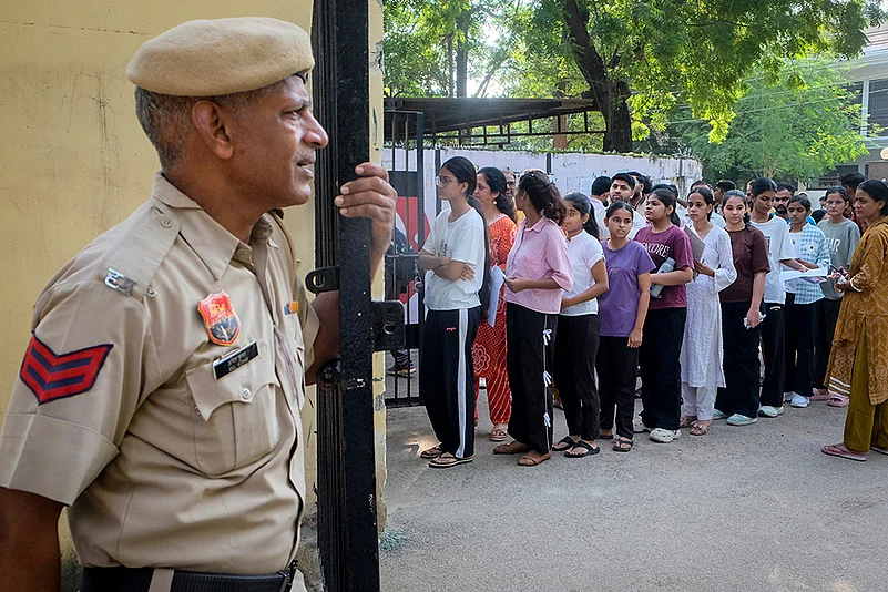 Aspirants wait in a queue before an examination in Gurgaon