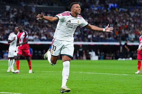 Real Madrid's Kylian Mbappe celebrates scoring his side's opening goal from the penalty spot during the Spanish La Liga soccer match between Real Madrid and Rayo Vallecano in Madrid, Spain.
