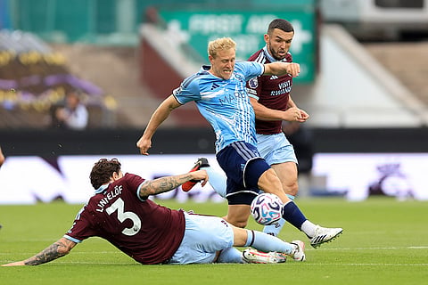 Aston Villa's Victor Lindelof, left, slides in on Nottingham Forest's Xaver Schlager during the English Premier League soccer match between Aston Villa and Nottingham Forest in Birmingham, England.
