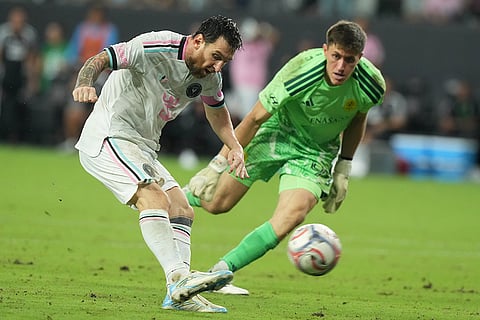 Inter Miami forward Lionel Messi (10) attempts a shot on goal ahead of Nashville goalkeeper Brian Schwake during the second half of an MLS soccer match in Miami.
