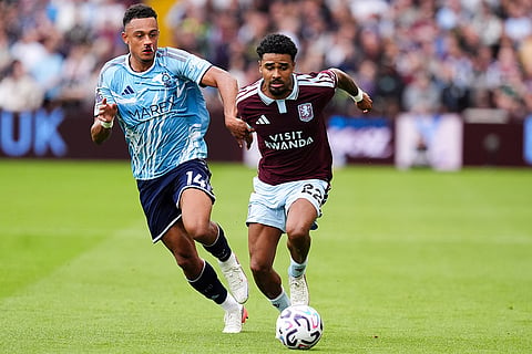Nottingham Forest's Dan Ndoye and Aston Villa's Ian Maatsen, right, battle for the ball during the English Premier League soccer match between Aston Villa and Nottingham Forest in Birmingham, England.