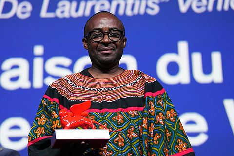 Director Auguste Bernard Kouemo Yanghu accepts the Luigi De Laurentiis debut film award for 'House of the Wind' during the closing ceremony of the 83rd edition of the Venice Film Festival in Venice, Italy.