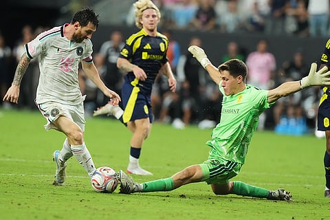 Nashville goalkeeper Brian Schwake attempts to stop a shot on goal by Inter Miami forward Lionel Messi during the second half of an MLS soccer match in Miami.