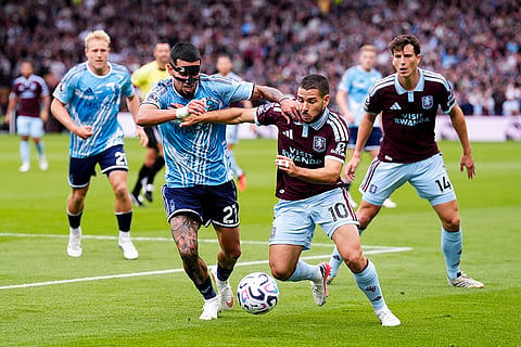 Aston Villa's Emiliano Buendia, right, and Nottingham Forest's Daniel Munoz battle for the ball during the English Premier League soccer match between Aston Villa and Nottingham Forest in Birmingham, England.