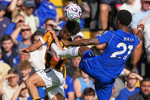 Hull City's Mohamed Belloumi, left, challenges for the ball with Chelsea's Jorrel Hato during the English Premier League soccer match between Chelsea and Hull City in London.