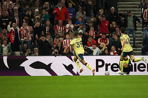 Arsenal's Bruno Guimaraes, center, celebrates after scoring the opening goal during the English Premier League soccer match between Sunderland and Arsenal in Sunderland, England.