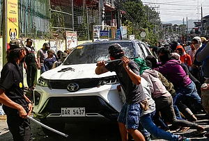 | Photo: AP : A group attacks a vehicle from an opposing group outside a school used as a polling center during the Bangsamoro Autonomous Region in Muslim Mindanao parliamentary elections in Cotabato city, southern Philippines, Monday, Sept. 14, 2026.