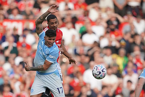 Manchester City's Enzo Fernandez, left, challenges for the ball with Manchester United's Youri Tielemans during the English Premier League soccer match between Manchester United and Manchester City in Manchester, England, Sunday, Sept. 13, 2026. 