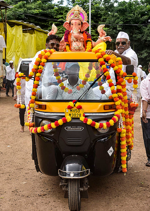 Devotees carry an idol of Lord Ganesh on an autorickshaw during the ‘Ganesh Chaturthi’ festival, in Karad, Maharashtra, Monday, Sept. 14, 2026. 