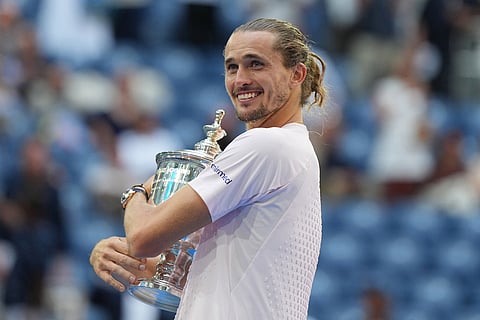 Alexander Zverev, of Germany, poses with the trophy after he won the men's singles final of the U.S. Open tennis championships against Ben Shelton, of the United States in New York.