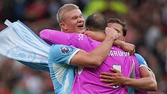 Manchester City's Erling Haaland, left, Manchester City's goalkeeper Gianluigi Donnarumma, Manchester City's Ruben Dias celebrate after the English Premier League soccer match between Manchester United and Manchester City in Manchester. - Ian Hodgson/AP Photo
