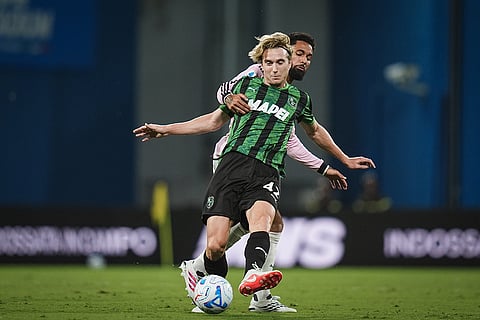 Sassuolo's Kristian Thorstvedt, front, and Juventus' Douglas Luiz, rear, challenge for the ball during the Serie A soccer match between Sassuolo Calcio and Juventus Turin in Reggio Emilia, Italy.
