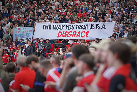 Manchester United fans display a banner ahead of the English Premier League soccer match between Manchester United and Manchester City in Manchester, England, Sunday, Sept. 13, 2026. 