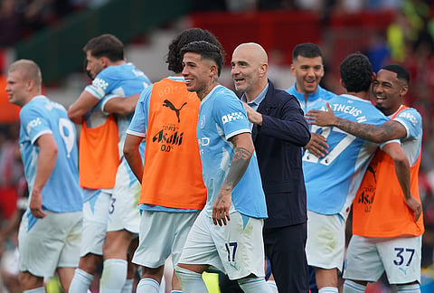 Manchester City's head coach Enzo Maresca, centre, celebrates with his players after the English Premier League soccer match between Manchester United and Manchester City in Manchester, England, Sunday, Sept. 13, 2026.