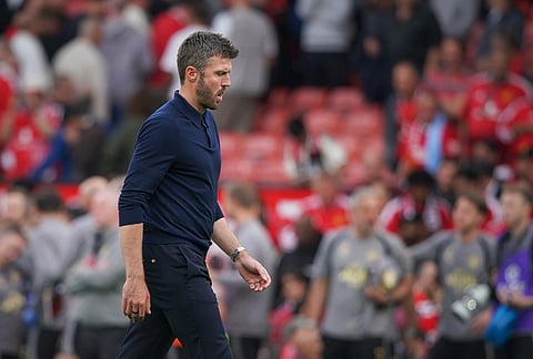 Manchester United's head coach Michael Carrick walks on the pitch at the end of the English Premier League soccer match between Manchester United and Manchester City in Manchester, England, Sunday, Sept. 13, 2026.