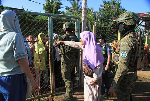 Muslim residents wait for their turn to enter a voting center during the Bangsamoro Autonomous Region in Muslim Mindanao parliamentary elections at a school in Saguiaran, Lanao del Sur province, southern Philippines, Monday Sept. 14, 2026. 
