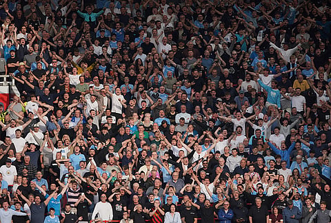 Man City fans cheer during the English Premier League soccer match between Manchester United and Manchester City in Manchester, England, Sunday, Sept. 13, 2026. 