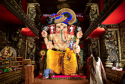 A woman offers prayers to a 24-foot-tall Lord Ganesh idol installed by Girgaon cha Raja Mandal during the ‘Ganesh Chaturthi’ festival, in Mumbai, Maharashtra, Monday, Sept. 14, 2026. 