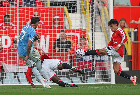 Manchester City's Enzo Fernandez, left, kicks the ball past Manchester United's Lisandro Martinez, right, during the English Premier League soccer match between Manchester United and Manchester City in Manchester, England, Sunday, Sept. 13, 2026.