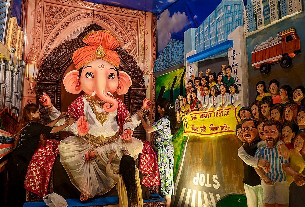 A Ganesh Chaturthi puja pandal themed on 'Parivartan – Towards a Developed Bengal with a Double Engine Government', depicting various events and issues in West Bengal alongside proposed development projects, at Baguihati, in Kolkata, Monday, Sept. 14, 2026. 
 - | Photo: PTI