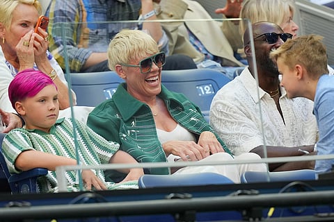 Pink, center, attends a match between Alexander Zverev, of Germany, and Ben Shelton, of the United States, during the men's singles final of the U.S. Open tennis championships in New York.