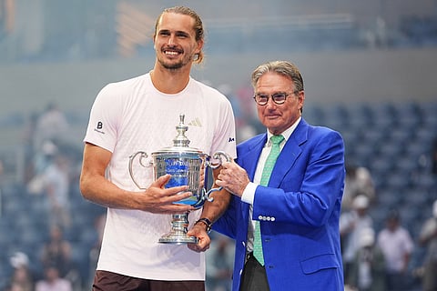 Alexander Zverev, of Germany, left, poses for a photo with former tennis player Jimmy Connors, right, after Zverev won the men's singles final of the U.S. Open tennis championships against Ben Shelton, of the United States  in New York.