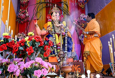 A priest performs a ritual during 'Ganesh Chaturthi' celebrations, in Nadia district, West Bengal.