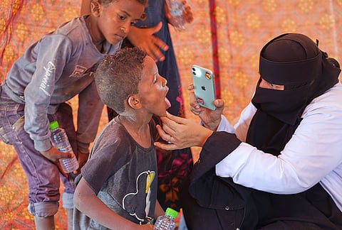 A doctor examines a displaced child at Al-Firdaws camp in Ras Imran, just outside Aden, Yemen, Monday, Sept. 14, 2026. 