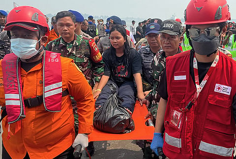 Rescuers carry a survivor from a passenger ferry overturned in bad weather in the Java Sea on a stretcher upon arrival at a port in Banjarmasin, South Kalimantan, Indonesia, Tuesday, Sept. 15, 2026. 